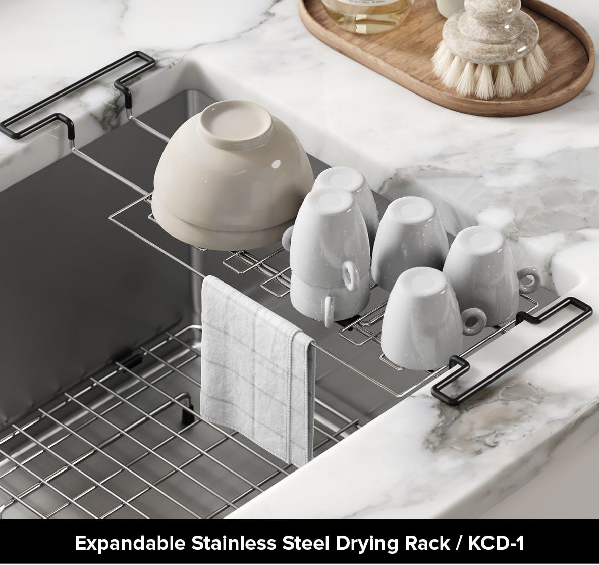 Kraus small expandable stainless steel drying rack with cups on white kitchen counter over stainless undermount sink