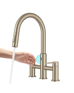 Spot-Free Antique Champagne Bronze Touchless Sensor Bridge Kitchen Faucet. A Woman hand is shown hovering over the sensor, activating the flow of water.